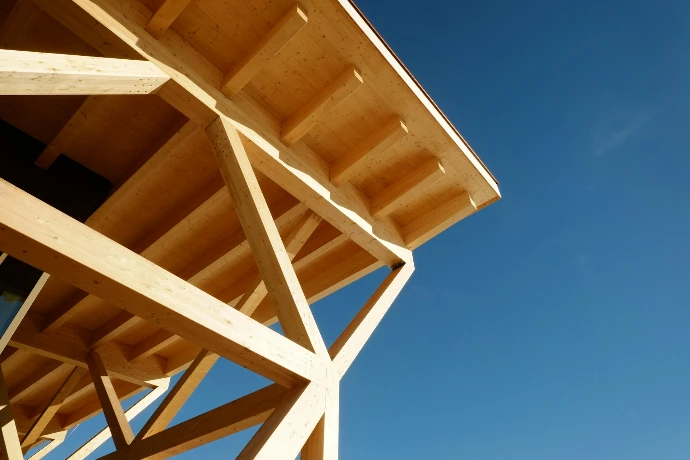 A close up of a wooden structure against a blue sky